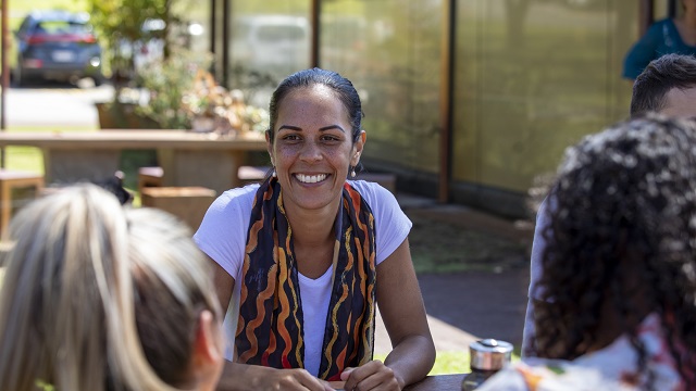 Close-up of young aboriginal students studying together outdoors in the sun in Australia.